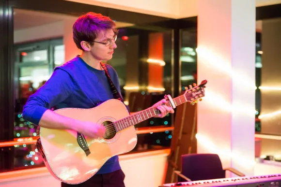 Student plays guitar