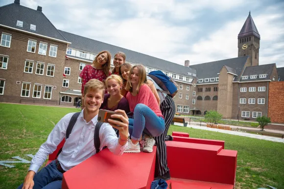 Students take a selfie in front of Radboud University building