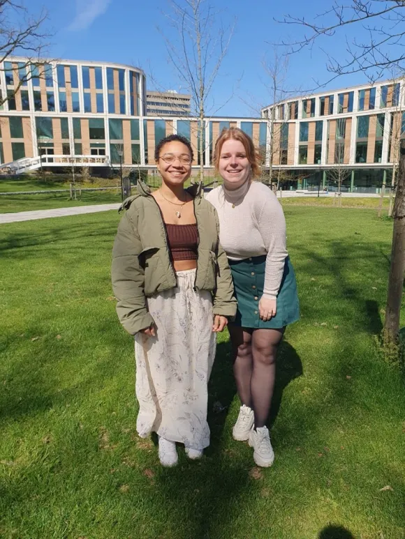Two people in front of Maria Montessori building