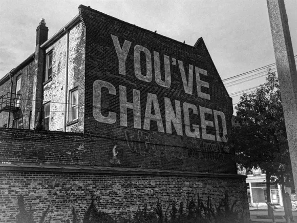 Building with graffiti saying 'you've changed'