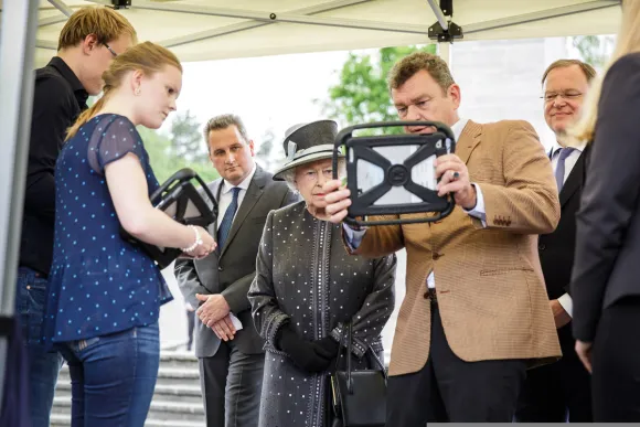 Paul Verschure shows Queen Elisabeth the Future Memory AR application for Bergen-Belsen