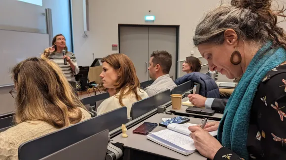 Women writes along at lecture