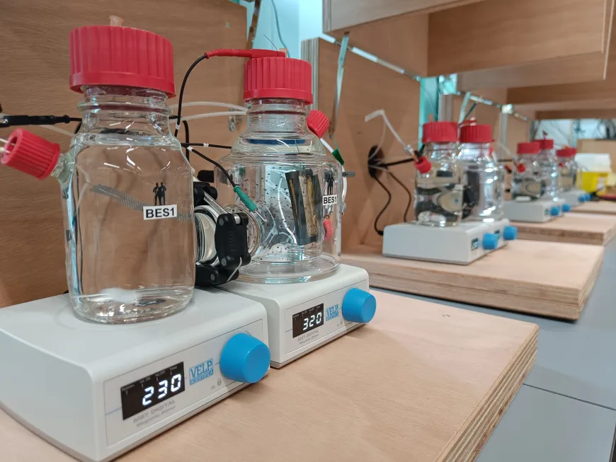 Several glass bottles marked BES1, BES2, etc, in a laboratory situation