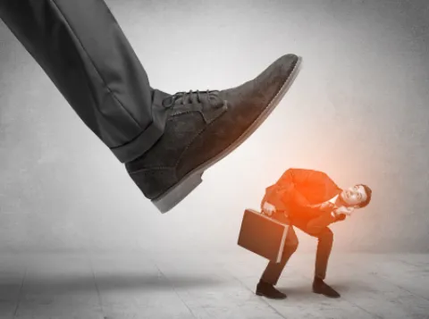 Foot stepping on a businessman.