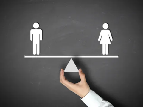 Man and woman balancing on a triangle