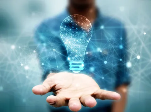 Hand holding lightbulb hologram.