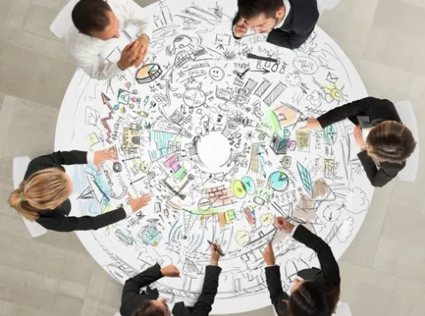 Six people sitting at a round table.