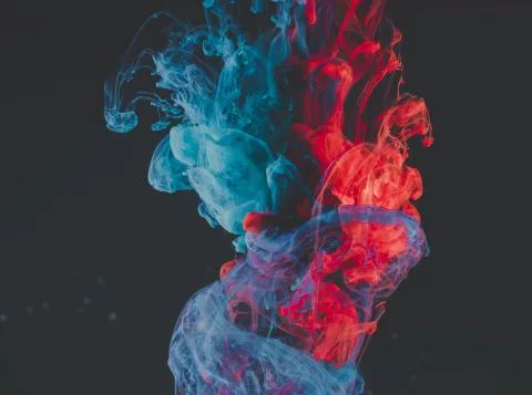 Abstract image of blue and red smoke coming together