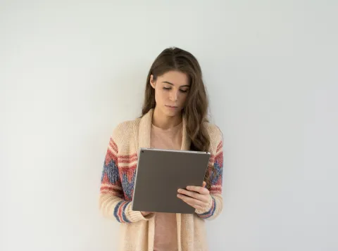 Woman reads on tablet