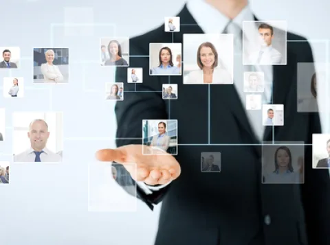 Man standing behind pictures of people