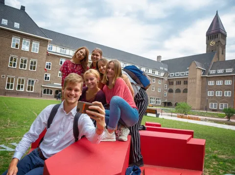 Students take a selfie in front of Radboud University building