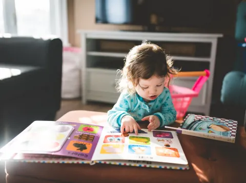 Child looking at pictures in children's book