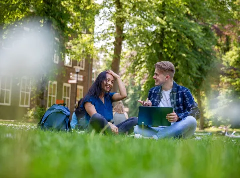 Students sitting in the grass in Summer