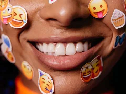 Women with emoji stickers on her face