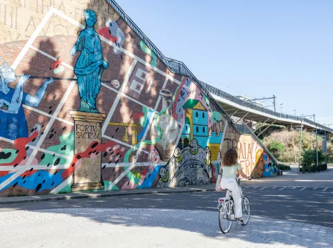 Roman Waalpainting on a bridge in Nijmegen with woman cycling 
