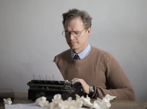 Man aan het schrijven op typmachine