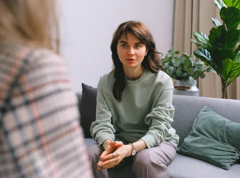 Vrouw op bank, in gesprek.