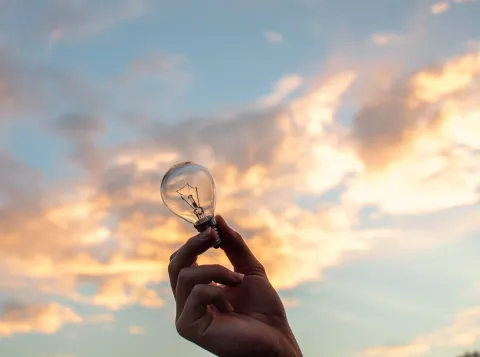 Person holding light bulb