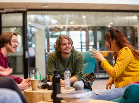 Students socializing in the Refter on campus