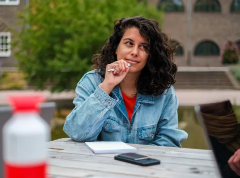 An employee sitting outside listening to someone