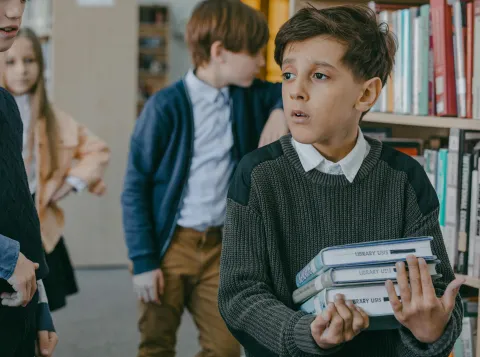 School pupil looks lost in a library