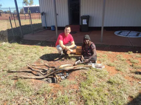 LM RojasBerscia and Dulcie Nanala cooking kangaroo tail