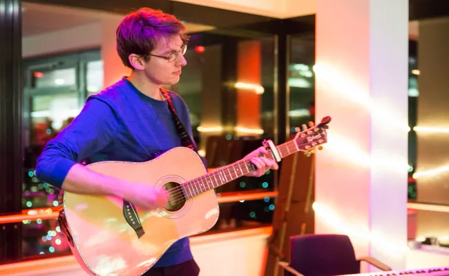 Student plays guitar