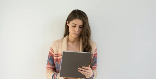 Woman reads on tablet
