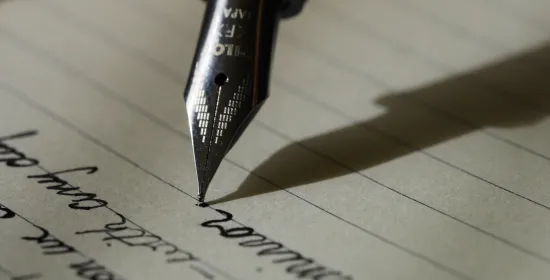 Close-up of a fountain pen writing on paper