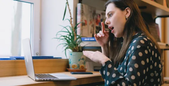 Woman signing in front of laptop