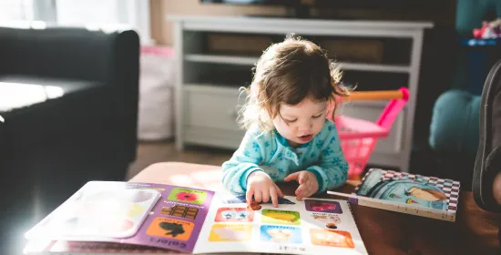 Child looking at pictures in children's book
