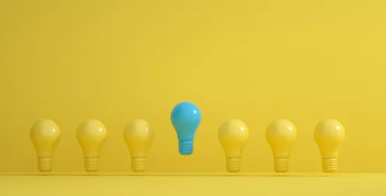 Row of yellow light bulbs and one blue one