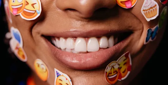 Women with emoji stickers on her face