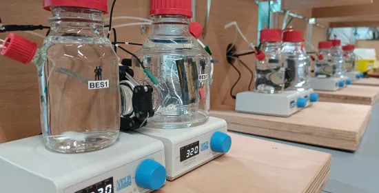 Several glass bottles marked BES1, BES2, etc, in a laboratory situation