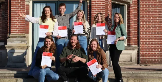 Jonge professionals juichend met certificaat