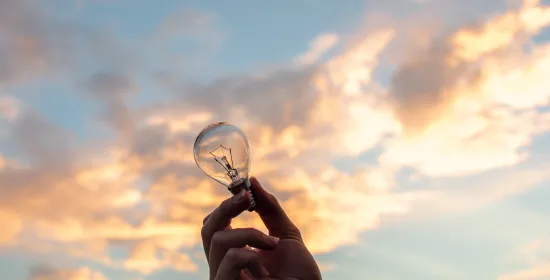 Person holding light bulb