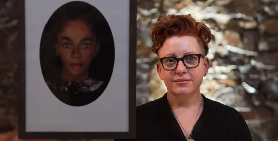 Artist Kathryn Smith poses next to reconstructed portrait of fugitive enslaved person