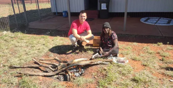LM RojasBerscia and Dulcie Nanala cooking kangaroo tail