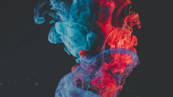 Abstract image of blue and red smoke coming together