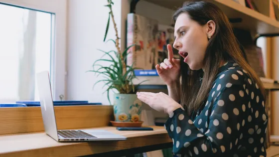 Woman signing in front of laptop