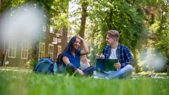 Students sitting in the grass in Summer