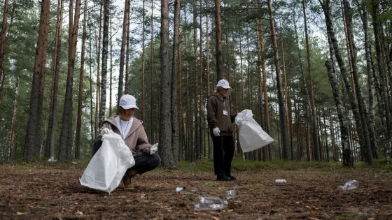 Two people picking up trash